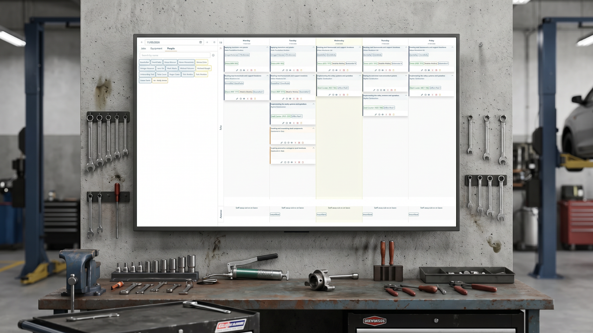 Digital workforce scheduling dashboard displayed in a workshop, providing real-time employee rostering, job planning, and resource allocation for field service operations.